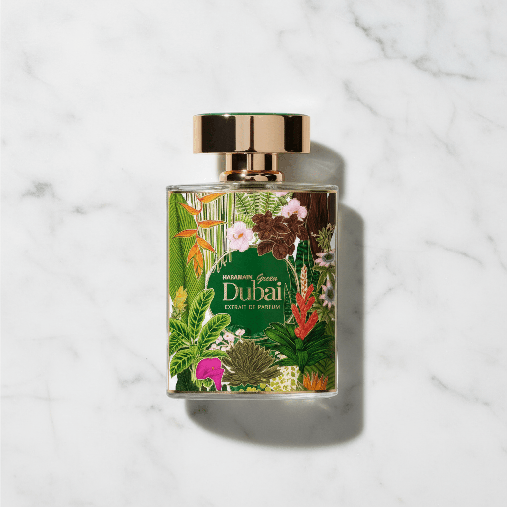 Perfume Green Dubai Extrait de Parfum da Al Haramain, frasco com estampa tropical floral colorida e tampa dourada, sobre mármore.