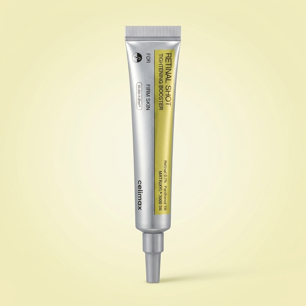 Booster facial Retinal Shot Tightening Booster da Celimax, bisnaga prateada e dourada, sobre fundo amarelo claro.