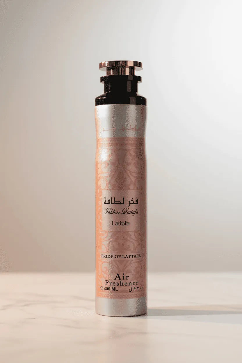 Air freshener Fakhar da Lattafa em frasco rosa com padrão árabe e tampa dourada, sobre superfície clara com luz suave